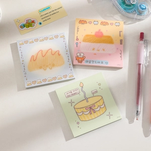 Detailed view of square cartoon sticky notes with creative dessert illustrations and pencils