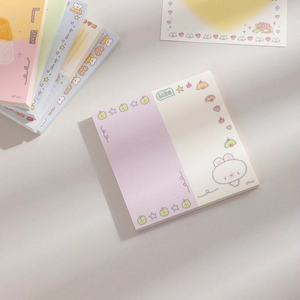 Close-up of stacked cartoon square memo pads with cute rabbit illustrations and macaron colors