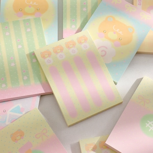 Flat lay of cute cartoon sticky notes with bear and rabbit motifs in pastel macaron colors