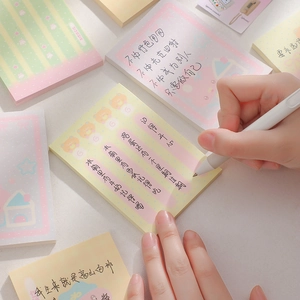 Cute cartoon bear sticky notes set in pastel colors being used for writing with a pen