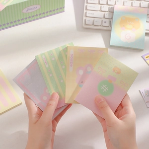 Macro shot of cute cartoon sticky notes in pastel colors with bear and rabbit designs