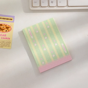Close-up of cute cartoon sticky notes with rabbit patterns and Korean text on a desk
