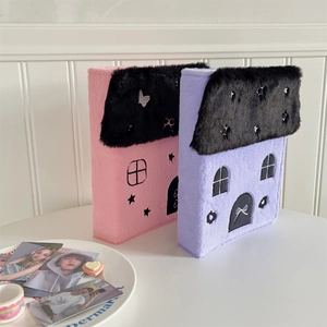 Detail showing the plush textures and embroidery of the purple cottage-shaped A5 photo album