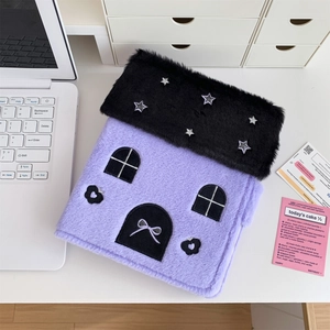 Detail of purple plush house-shaped photo album with star embroidery and magnetic buckle