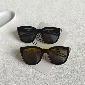 Retro small frame sunglasses with cut-out temples in black and yellow color variants