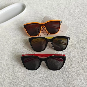 Three pairs of vintage hollow-out small frame sunglasses in orange, yellow, and red colors