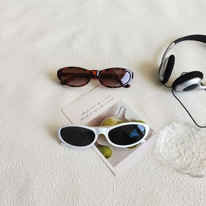 Retro cat-eye sunglasses set in tortoiseshell and white frames for a trendy Y2K aesthetic