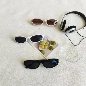 Retro cat-eye sunglasses set in beige white and black frames for a stylish vintage look
