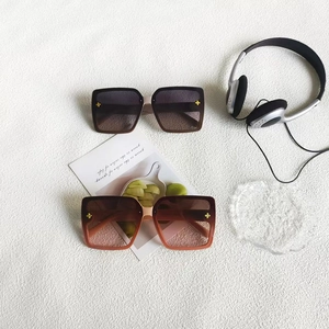 Oversized square sunglasses with gradient lenses and decorative gold floral accents