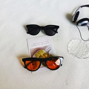 Retro cat-eye sunglasses with thick black frames and tinted lenses for UV400 protection