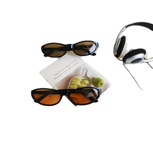 Retro cat-eye sunglasses with oval black frames and tinted lenses for a vintage fashion look