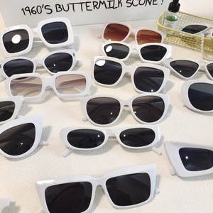 Flat lay of retro white sunglasses collection featuring cat eye and oval frame designs