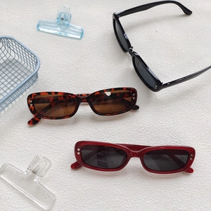 Chic rectangle sunglasses in black, tortoise, and red frames with a retro 2025 aesthetic