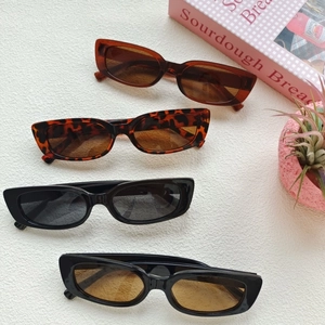 Vintage rectangular sunglasses set in tortoise, amber, and black frames with gradient lenses