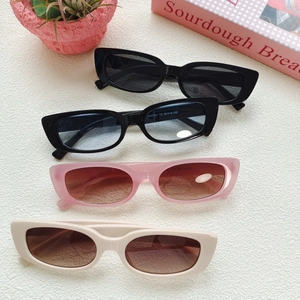 Detail of square vintage sunglasses in multiple colors stacked on a trendy background