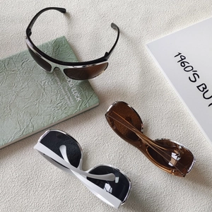 Y2K oval wraparound sunglasses in silver, brown, and white on a textured surface