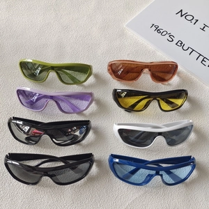 Set of eight stylish Y2K oversized sunglasses in various colors on textured background
