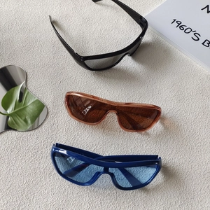 Three Y2K oversized sports sunglasses in black, brown, and blue with a sleek shield design