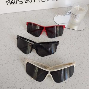 Foldable kids sports sunglasses in red, black, and white with streamlined windproof lenses