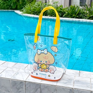 Detail of waterproof PVC beach bag with cartoon dog print and yellow handles poolside