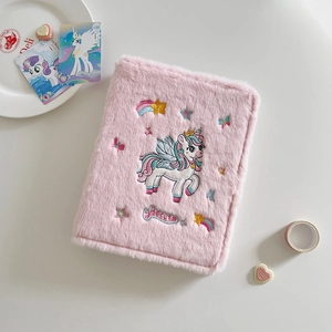 Close-up of plush pink A5 binder with unicorn embroidery and soft texture details
