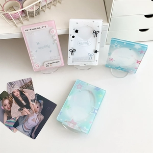 Detailed view of acrylic photo card holders with decorative themes and transparent stands
