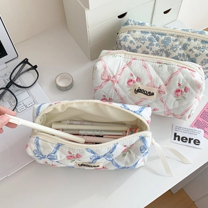 Quilted floral pencil pouch with large capacity, featuring cute bows and zip closure