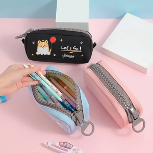 Detailed view of canvas pencil case featuring a creative oversized grey chunky zipper