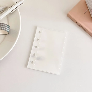 Macro detail of a translucent frosted 6-hole loose-leaf binder storage pocket for A5 binders