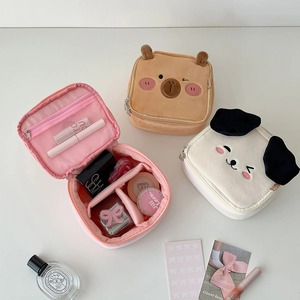 Detail showing plush cosmetic bags with 180-degree opening and adjustable inner dividers