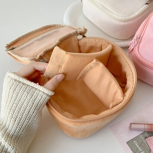 Detail of velvet makeup bag with adjustable velcro dividers and internal mesh pocket