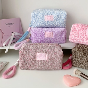 Detailed view of colorful plush leopard print makeup bags with soft fur and handles