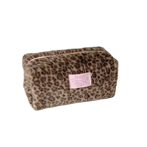 Winter plush leopard print cosmetic bag with soft faux fur texture and pink zipper closure