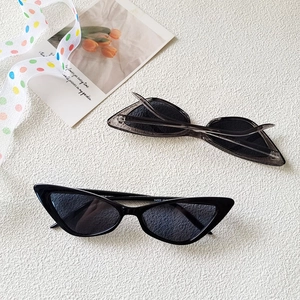 Flat lay of cat-eye sunglasses in black and grey with UV protection lenses and 24002 model