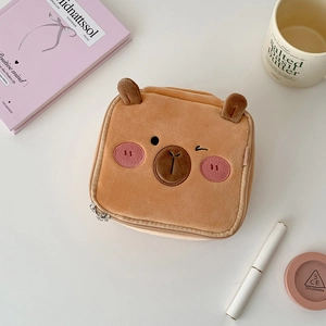 Close-up of brown plush bear cosmetic bag with soft texture and detailed embroidery