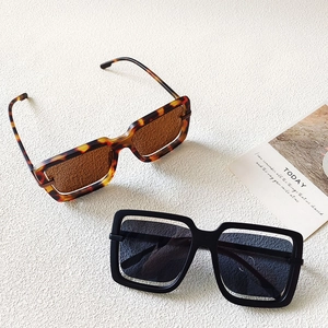 Close-up of oversized hollow square sunglasses in tortoiseshell and black frames
