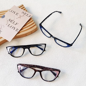Three pairs of lightweight cat-eye kids glasses frames in black, leopard, and navy blue