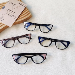 Flat lay of cat-eye kids glasses frames in black, tortoiseshell, and pink color options
