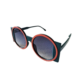 Fashionable oversized round lens sunglasses with bold geometric red and green frames