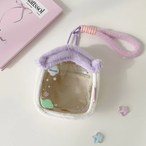 Close-up of house-shaped plush doll display bag with transparent window and purple handle