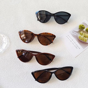 Ultralight cat-eye black frames and tortoise shell eyewear set on a textured background
