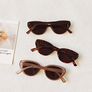 Close-up of three vintage cat eye sunglasses in leopard, coffee, and tan finishes