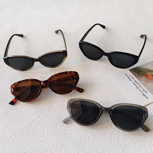 Flat lay of retro cat eye sunglasses in black, tortoiseshell, and transparent frames