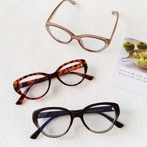 Retro cat-eye eyewear frames in transparent tea, leopard, and black colors on white background