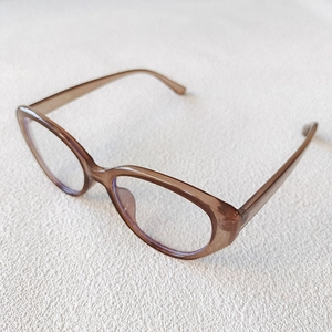 Close-up of vintage cat-eye glasses frame in transparent tea brown finish on white background