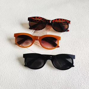 Three retro rectangle sunglasses in leopard, amber, and black frames on a textured background