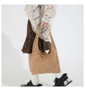 Détail du sac hobo en daim marron avec rivets argentés et design de seau personnalisé