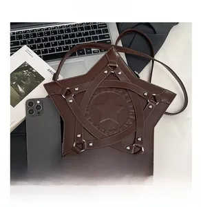 Detail shot of a dark brown star-shaped leather crossbody bag with punk style metal rivets