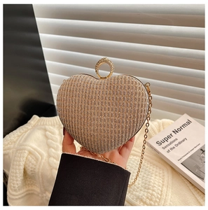 Détail de la pochette de soirée en forme de cœur avec paillettes et fermoir en diamant