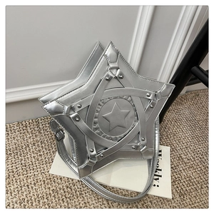 Detail of silver star-shaped shoulder bag with metallic finish and rivet studs